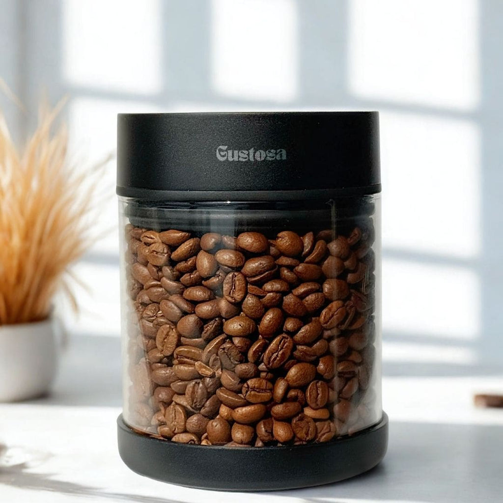 Close-up of the Gustosa Vacuum Container packed with whole roasted coffee beans, showcasing how the airtight seal preserves freshness and aroma with the transparent glass body making contents clearly visible.