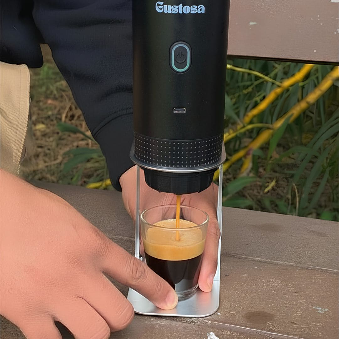 A person brewing a rich creamy espresso with MyGustosa portable coffee maker placed on the Gustosa Bracket on an outdoor wooden table, showing how stable and hands-free the brewing experience is outside.