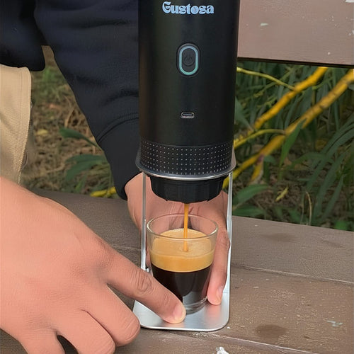 A person brewing a rich creamy espresso with MyGustosa portable coffee maker placed on the Gustosa Bracket on an outdoor wooden table, showing how stable and hands-free the brewing experience is outside.