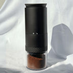 Gustosa electric coffee grinder with fresh ground coffee in the transparent container – compact and portable design